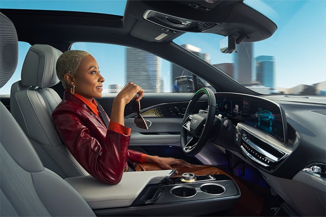 Woman driving hands-free with Super Cruise driver assistance technology