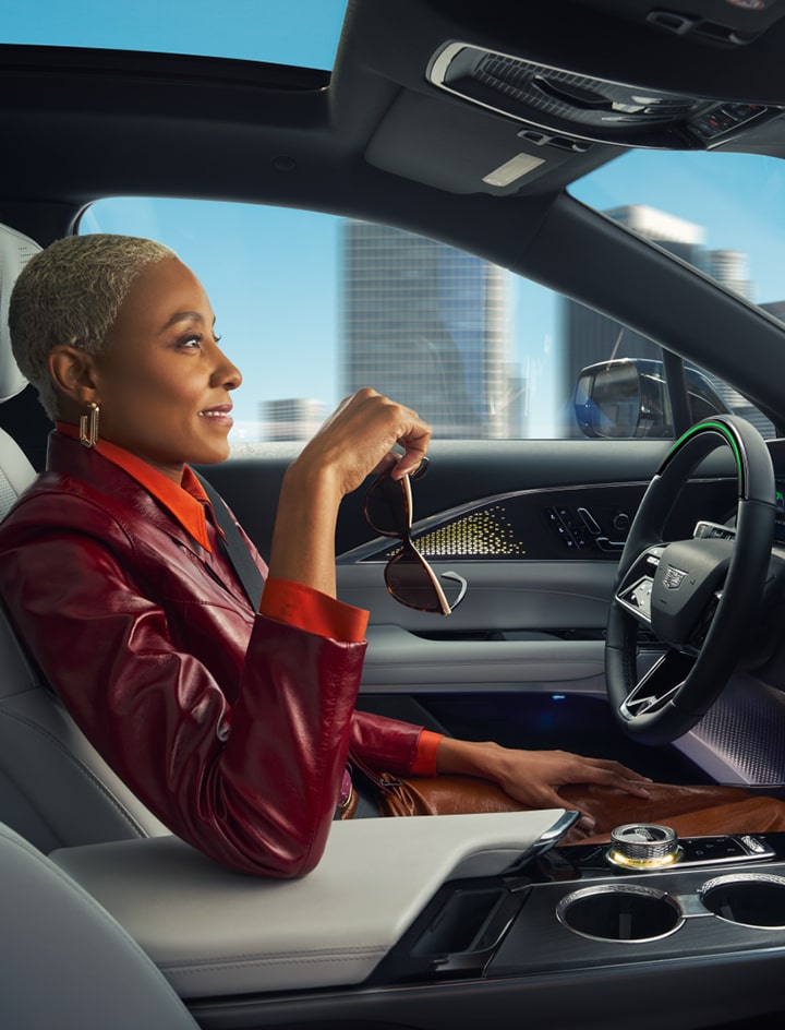 Woman driving hands-free with Super Cruise driver assistance technology