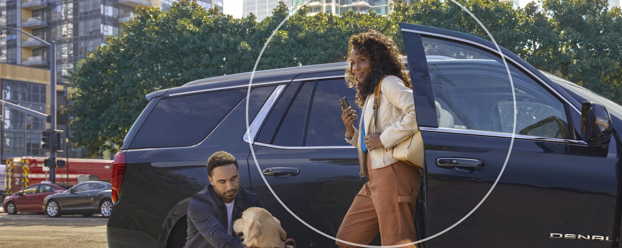 Woman Exiting Her Vehicle While Checking Her Phone 