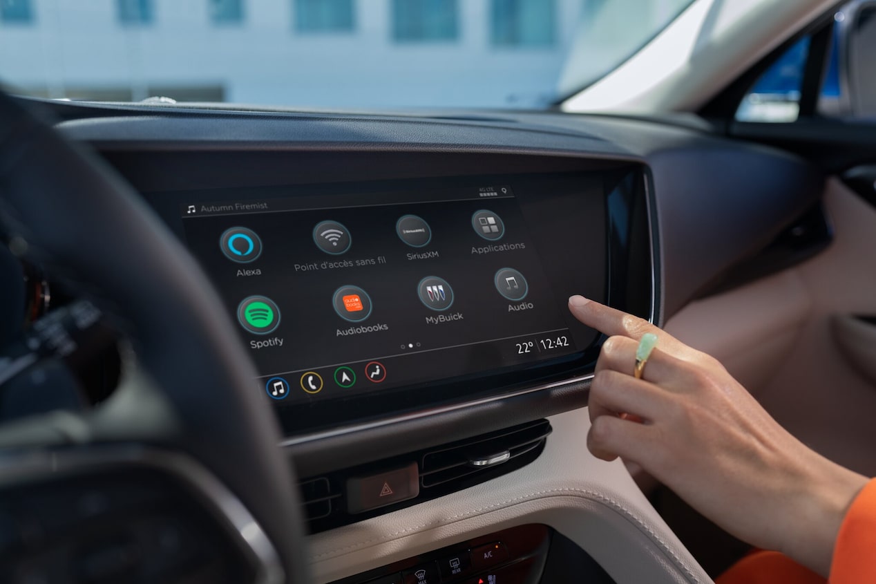 Woman reaching to touch her vehicle screen