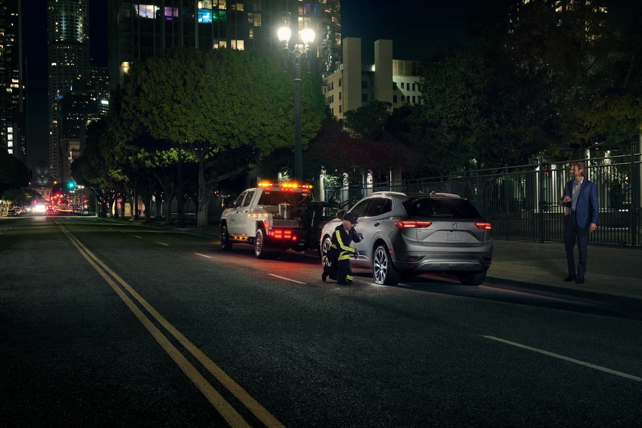 Roadside Assistance Working on a Vehicle During the Night