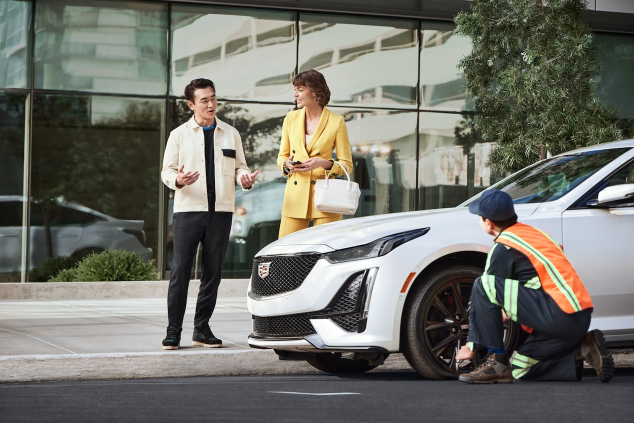 Roadside Assistance Worker Assisting Couple with Their Vehicle