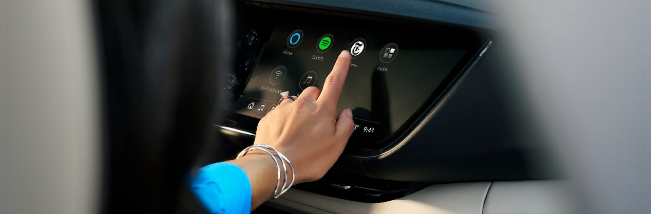 Woman Sitting in Passenger Seat Using Infotainment System