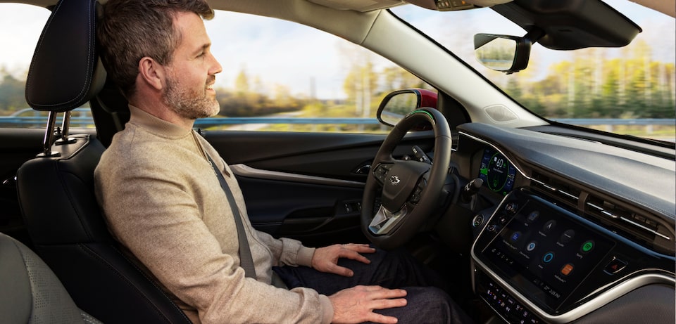 Man Sitting in Drivers Seat Using GM Super Cruise Hands-Free Technology