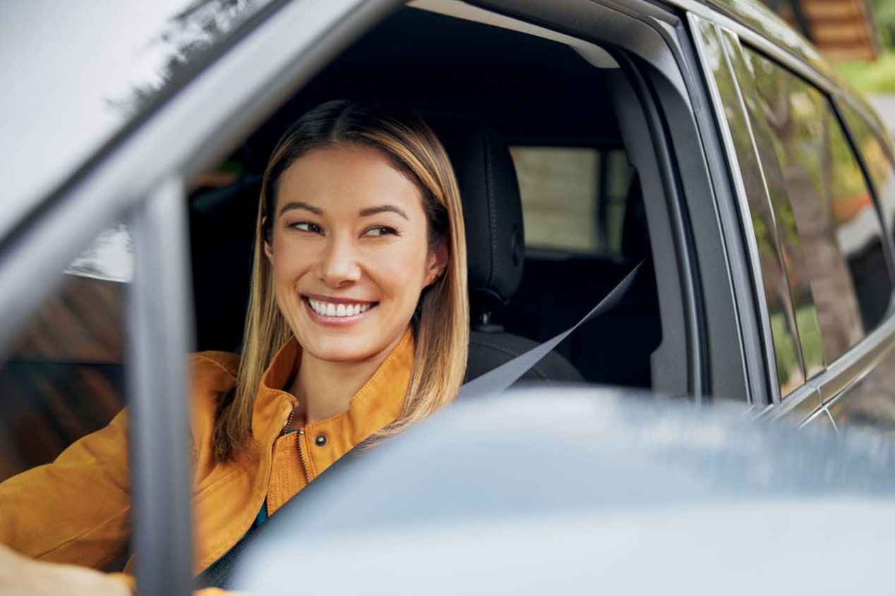 Women in Drivers Seat Smiling