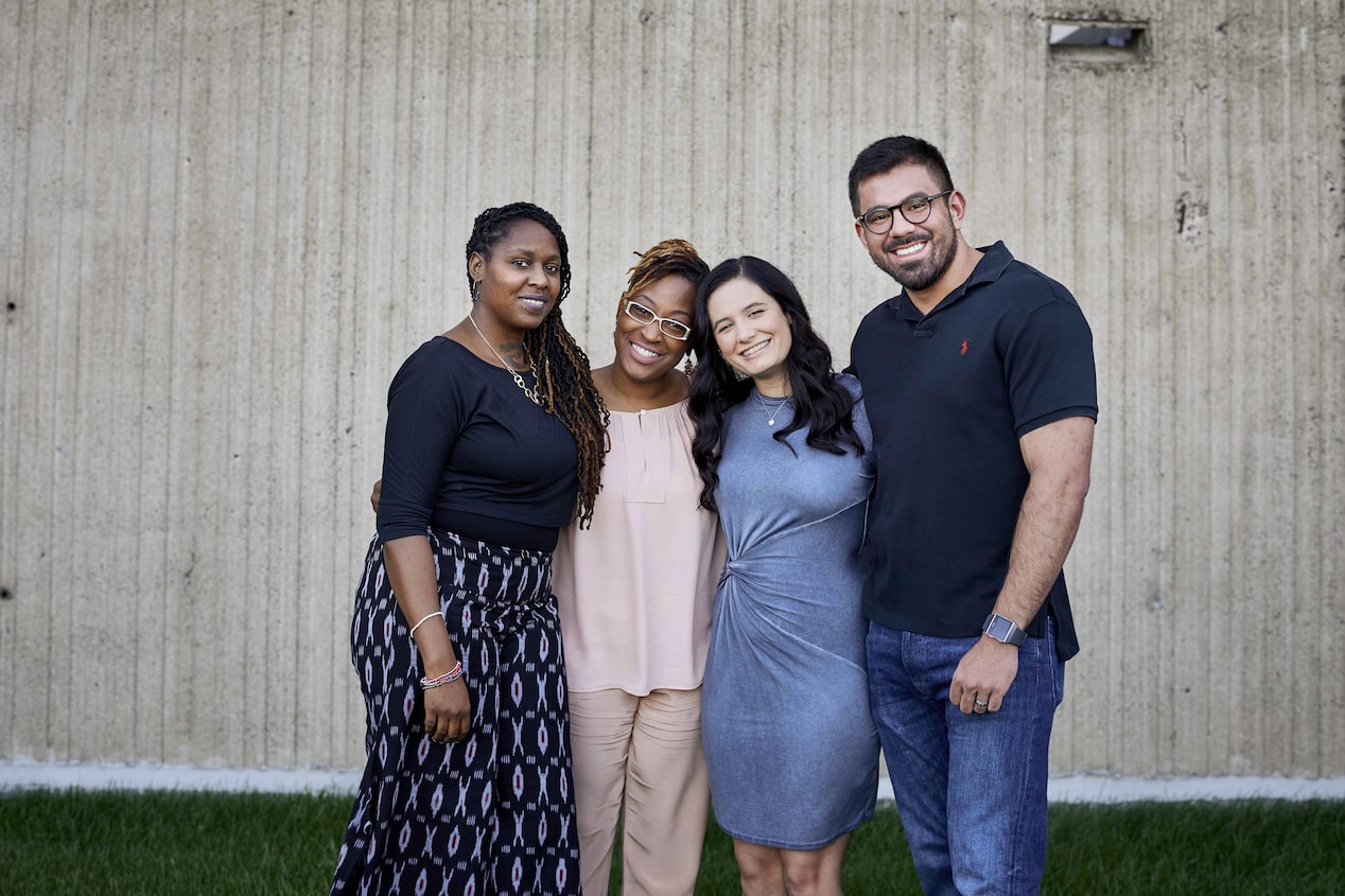 Four Friends Standing Side by Side Smiling