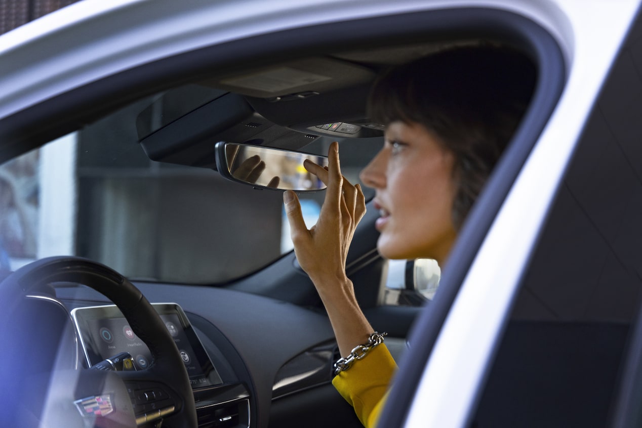 Close-Up of Woman in Yellow Pressing the OnStar Button