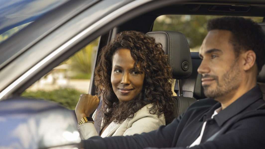 Woman in Passenger Seat Smiling at Man Driving