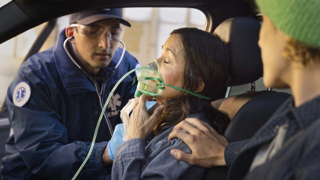 Child Wearing Headphones Plays on Tablet in the Backseat