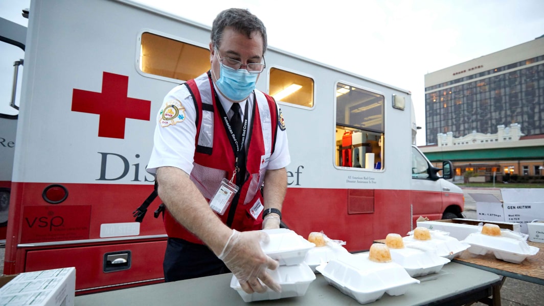 Man in Front of Red Cross Vehicle