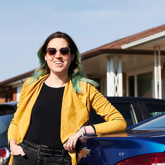 Women Smiling Leaning Against Vehicle