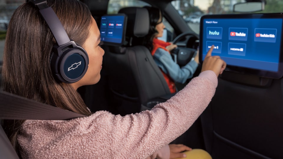 Backseat Passenger Choosing Entertainment on a Headrest