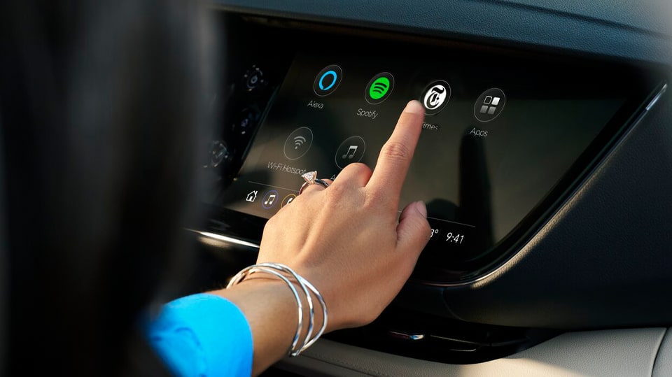 Woman Sitting in Passenger Seat Using Infotainment System