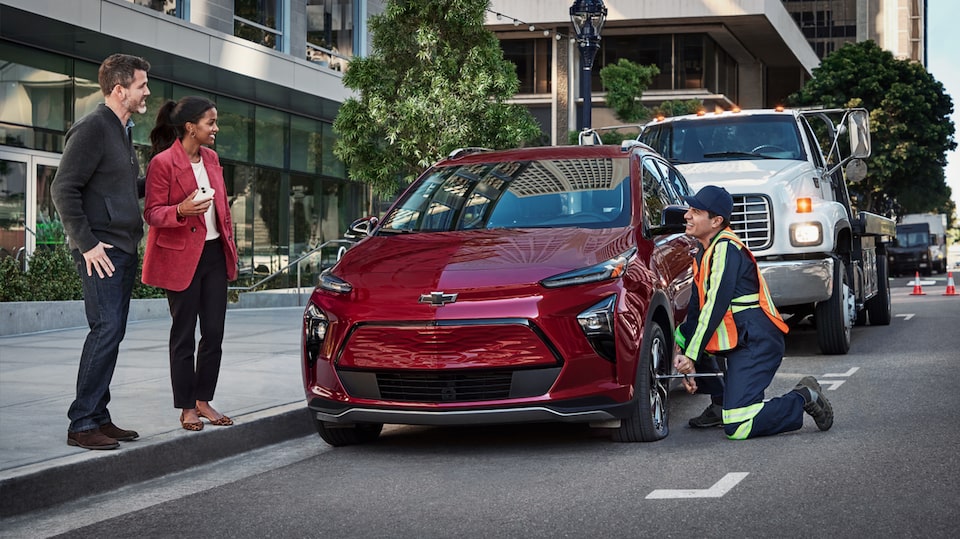 Roadside Assistance Happily Working on a Chevy