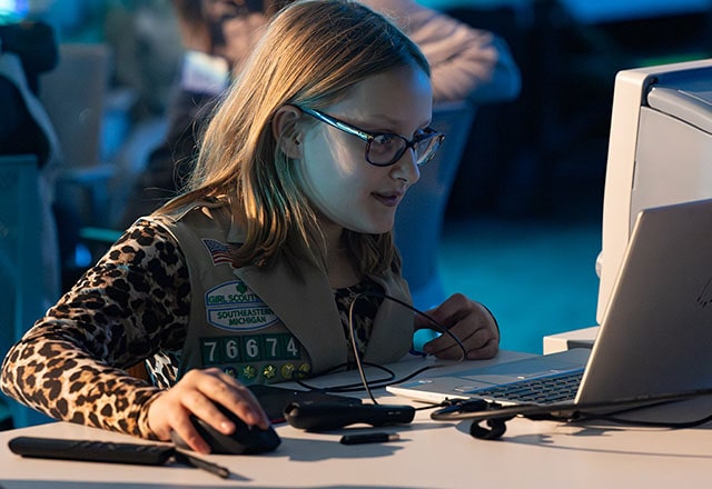 A young Girl Scout using a computer