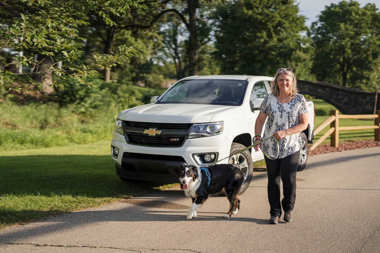 Women Walking Dog in Front of Chevy SUV