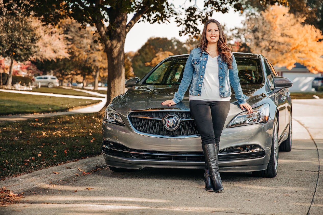 Woman Leaning on the Front of a Buick Car