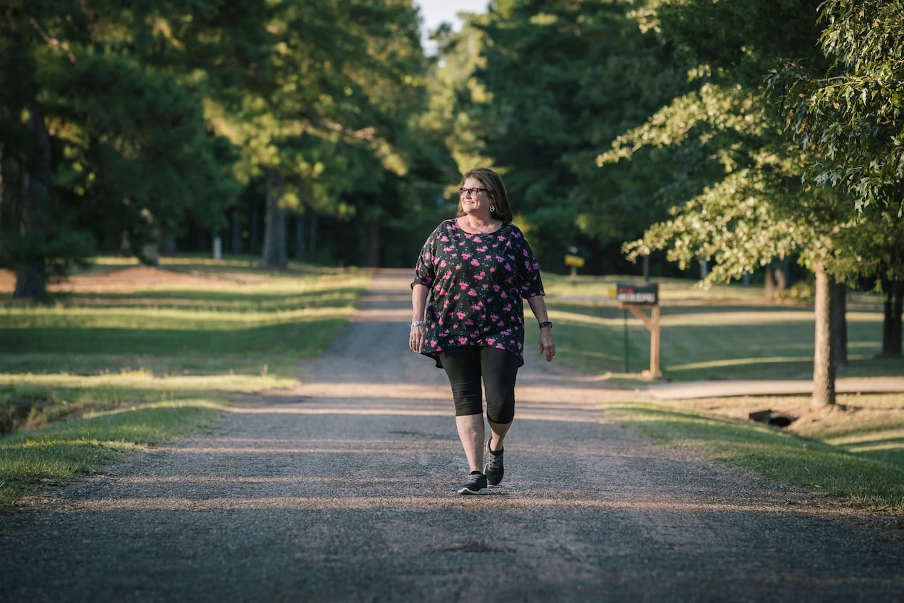 Woman Walking Down the Middle of a Road