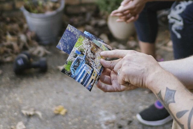 Family Showing Pictures of Hurrican Disaster 