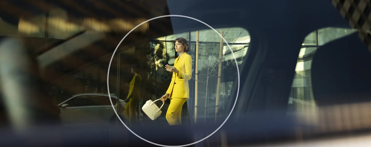 Woman Walking out of a Building Using her Smartphone