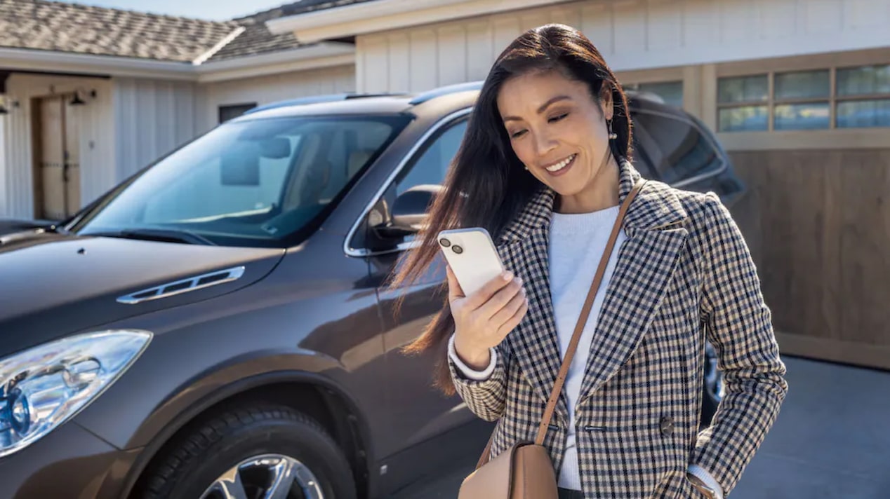 A Woman Double Checks that Her Vehicle is Locked Using her Mobile App