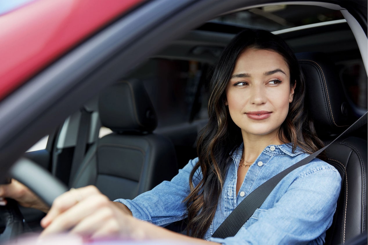 Woman Driver Lightly Smiling out Her Car Window