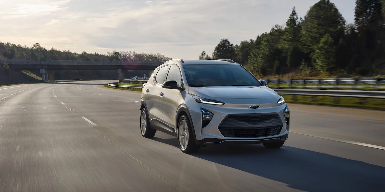 GM SUV Driving Down a Bare Three Lane Highway