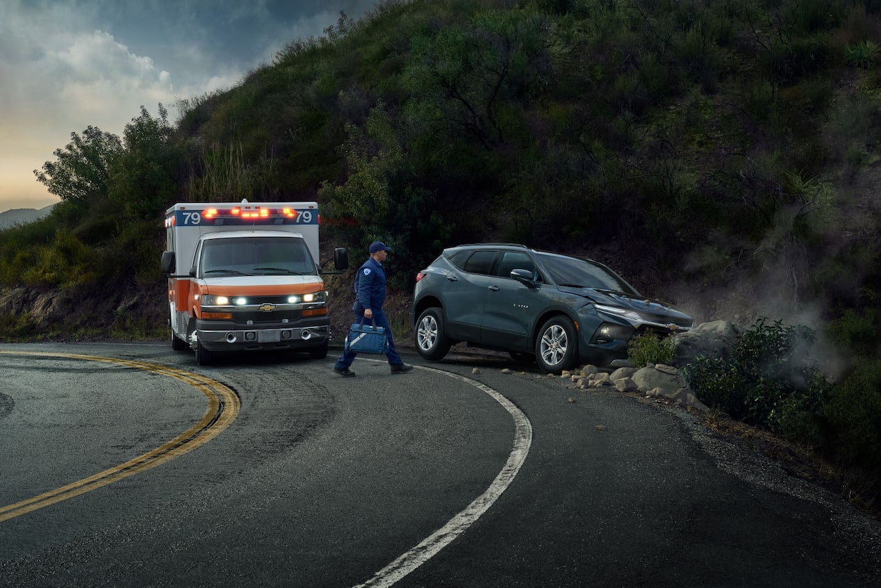 EMT Approaches a Crashed Vehicle on the Side of the Road