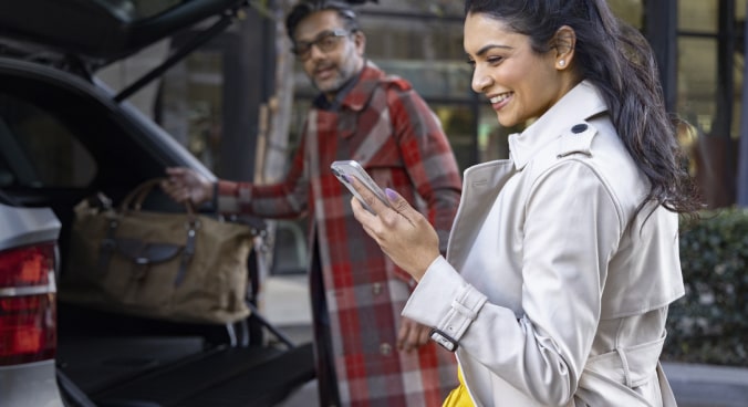 Woman smiling looking at her smartphone