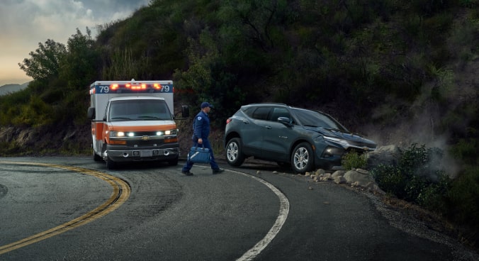 EMT Walking Towards a Crashed Vehicle on the Side of the Road